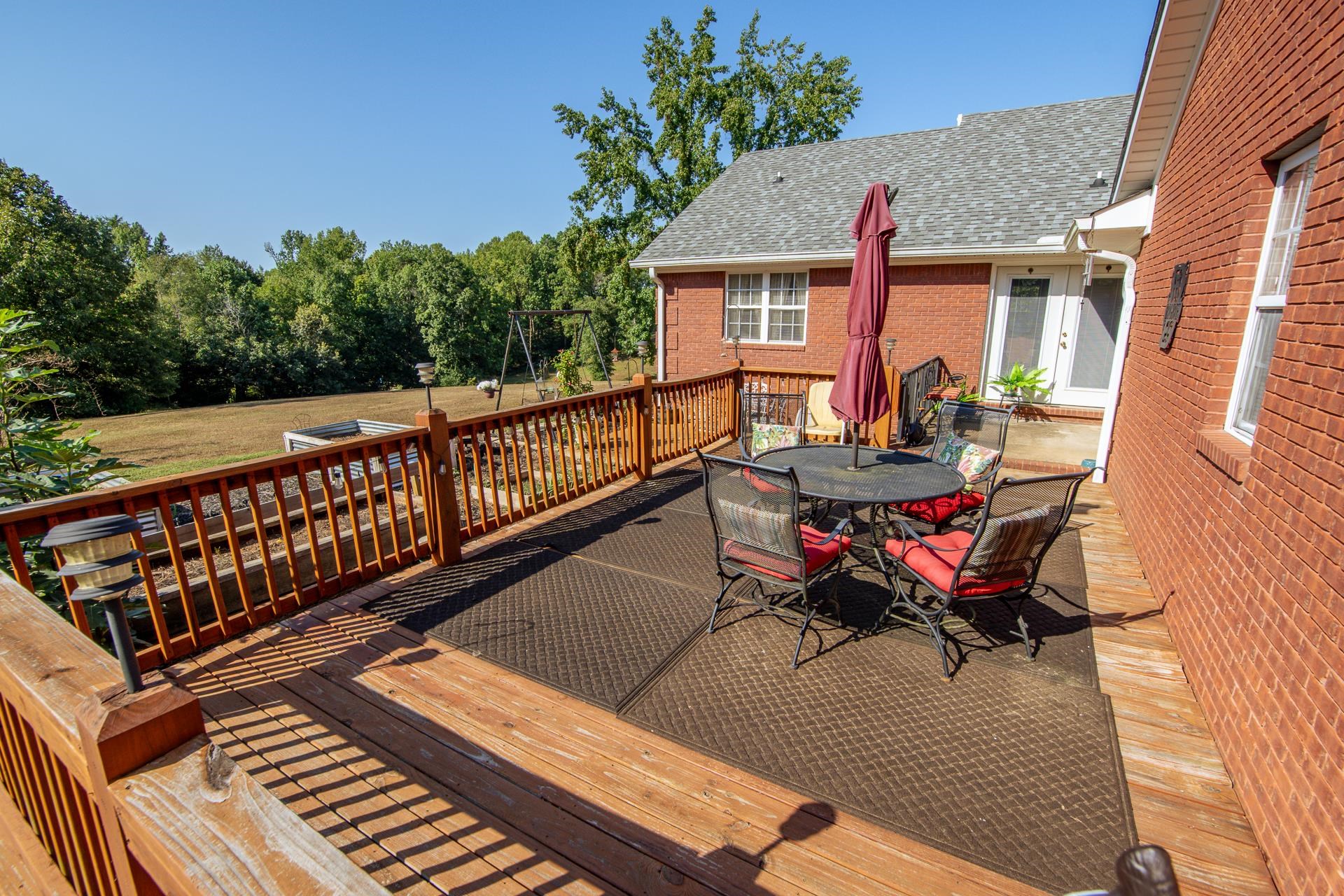 880 Double Springs Loop Savannah, TN 38372 - Photo 20 of 40 a balcony with wooden floor and outdoor seating