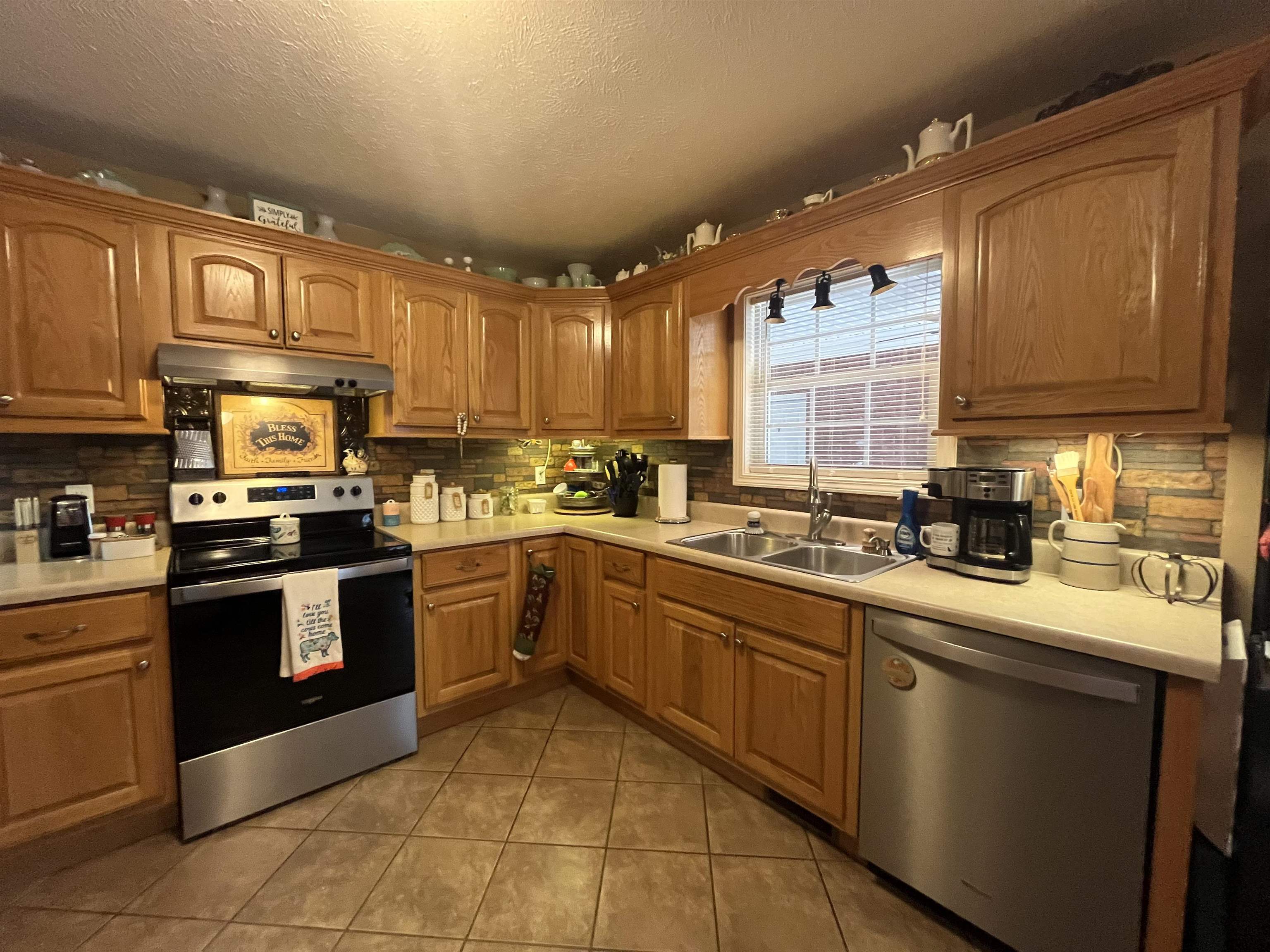 880 Double Springs Loop Savannah, TN 38372 - Photo 2 of 40 a kitchen with stainless steel appliances granite countertop a stove sink and cabinets