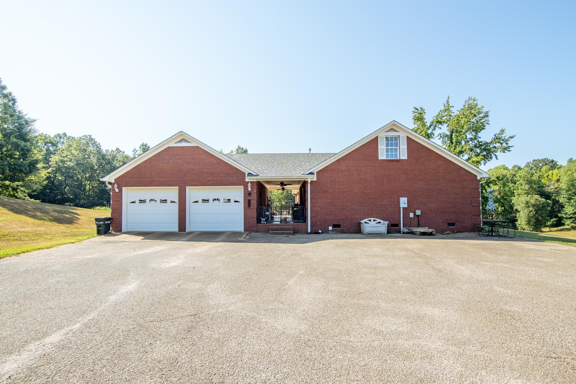 880 Double Springs Loop Savannah, TN 38372 - Photo 26 of 40 a front view of house with yard and trees in the background