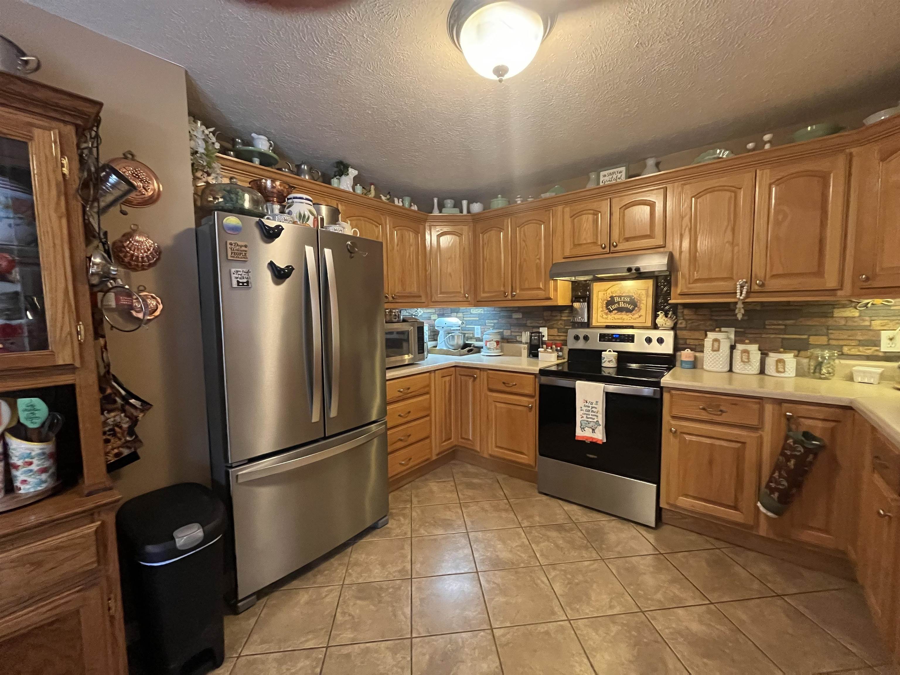 880 Double Springs Loop Savannah, TN 38372 - Photo 4 of 40 a kitchen with granite countertop a refrigerator and a stove top oven