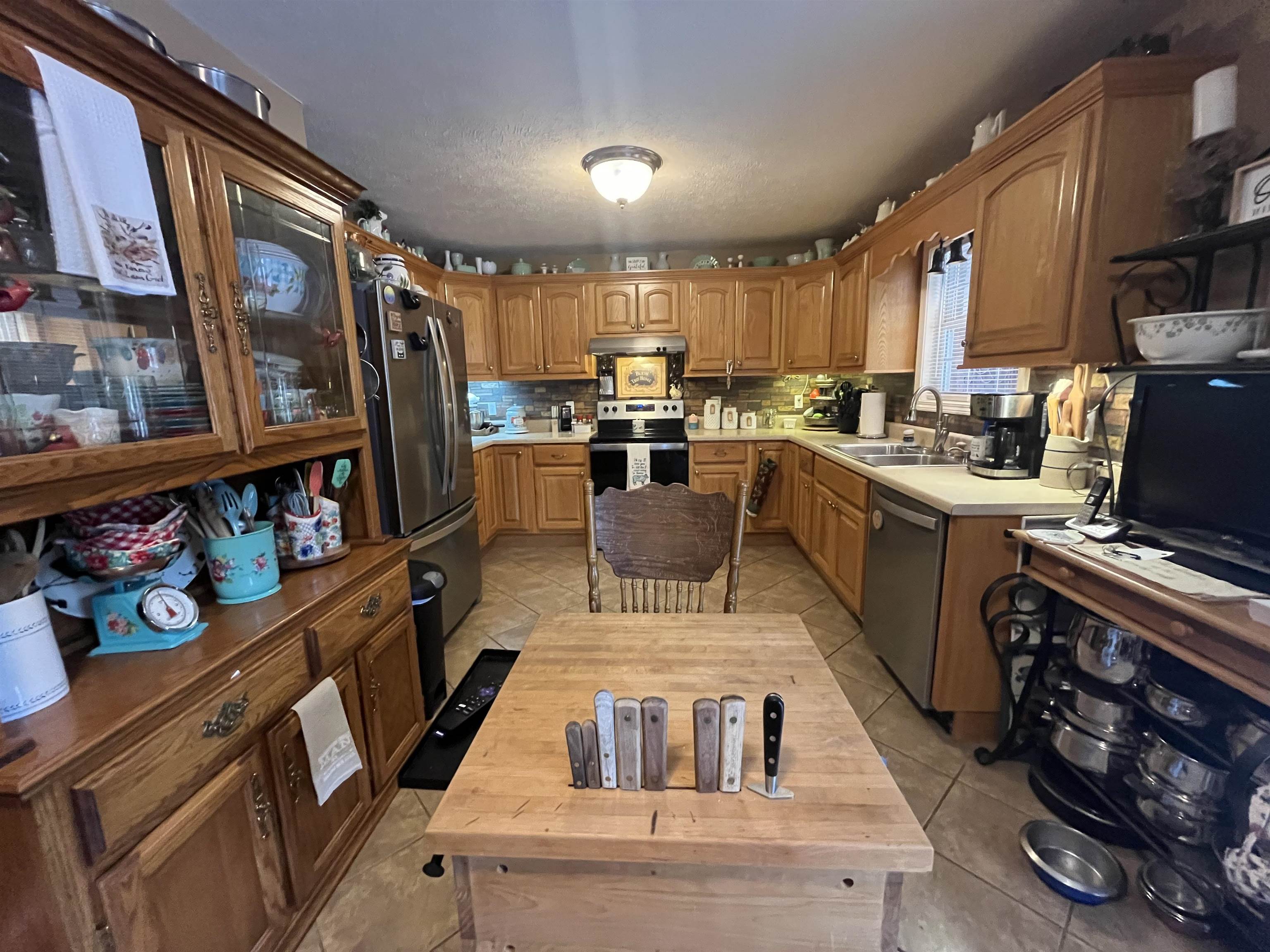 880 Double Springs Loop Savannah, TN 38372 - Photo 5 of 40 a kitchen with lots of appliances and wooden floor