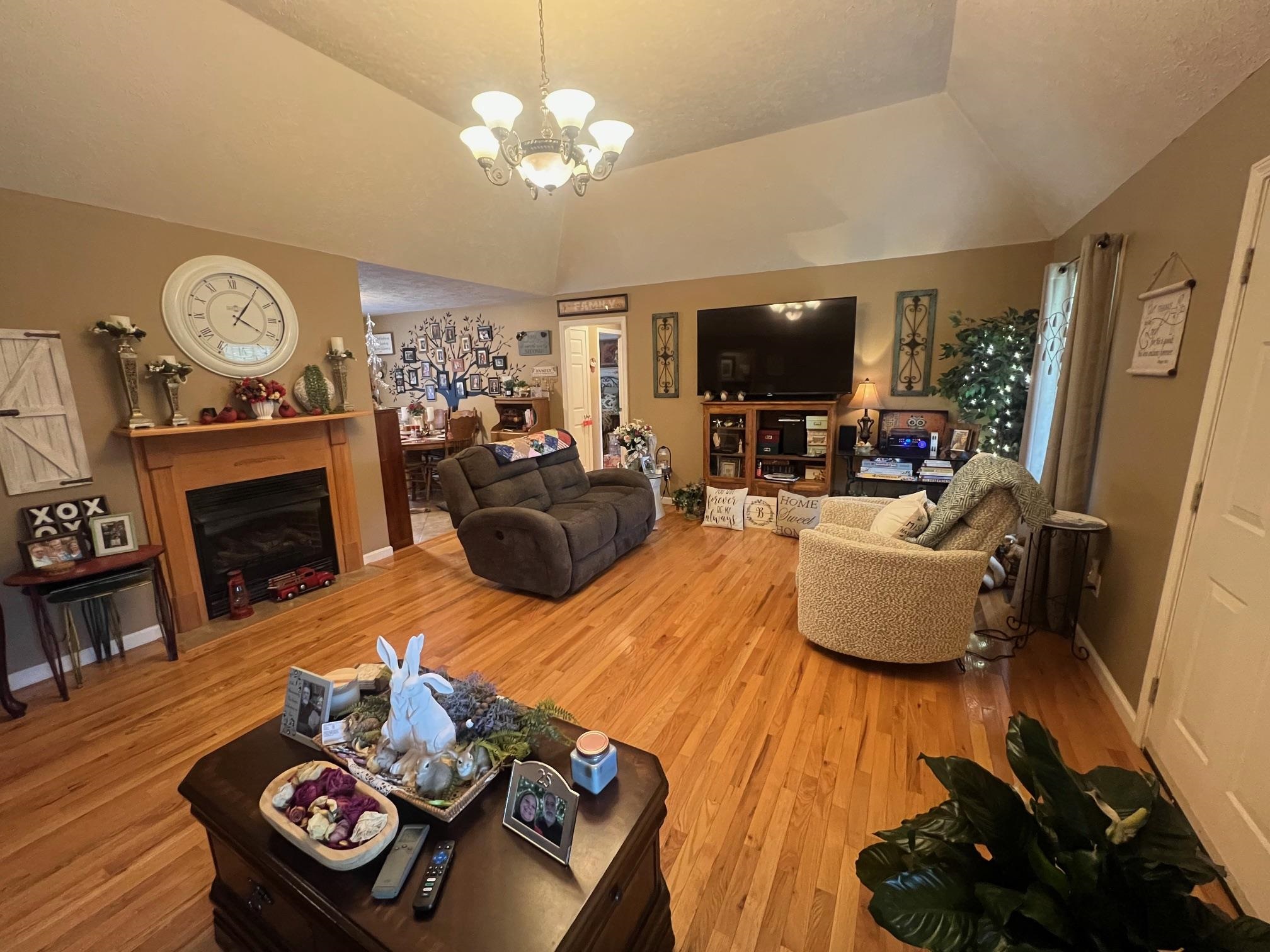 880 Double Springs Loop Savannah, TN 38372 - Photo 8 of 40 a living room with furniture a flat screen tv and a fireplace