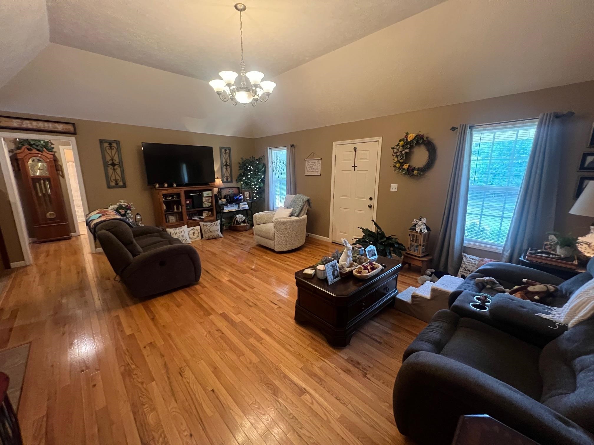 880 Double Springs Loop Savannah, TN 38372 - Photo 9 of 40 a living room with furniture and a chandelier