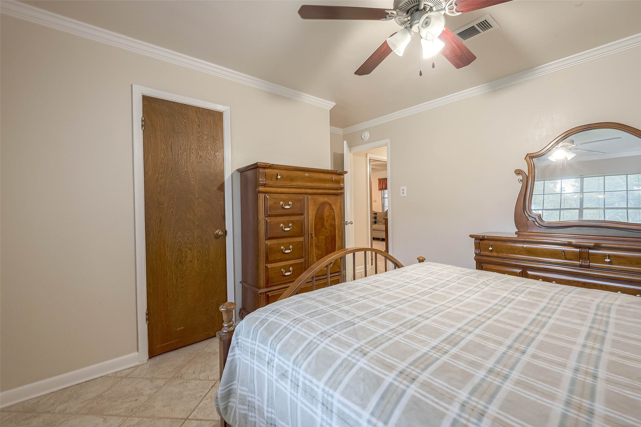 1503 Miles Street Rosenberg, TX 77471 - Photo 13 of 25 a bedroom with a bed and a chandelier
