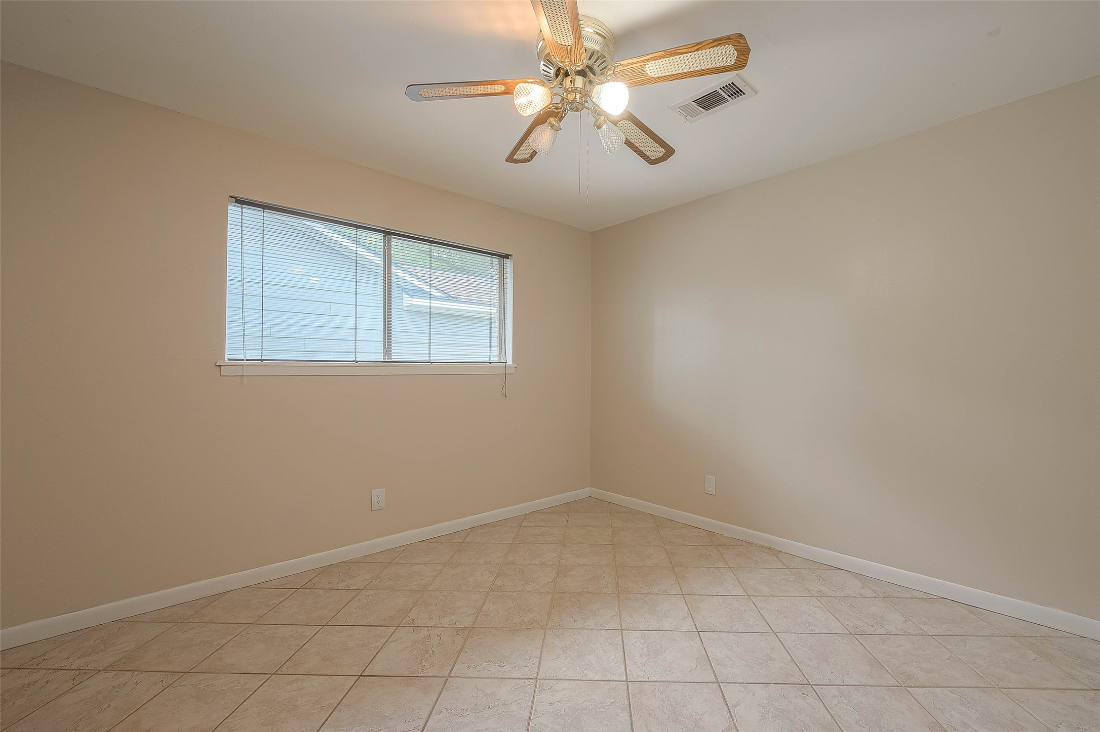1503 Miles Street Rosenberg, TX 77471 - Photo 14 of 25 an empty room with a window and ceiling fan