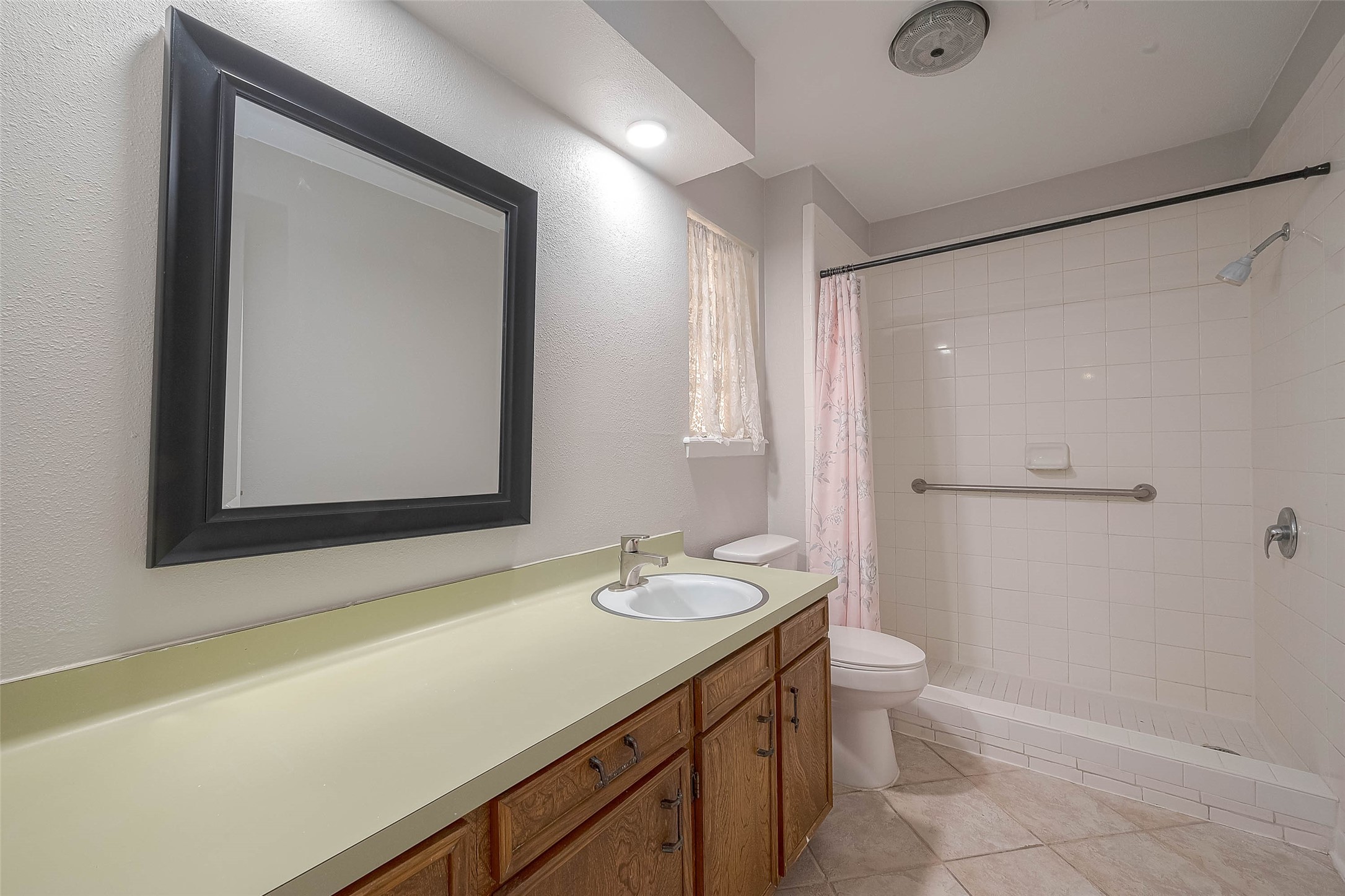 1503 Miles Street Rosenberg, TX 77471 - Photo 16 of 25 a bathroom with a sink a toilet and shower