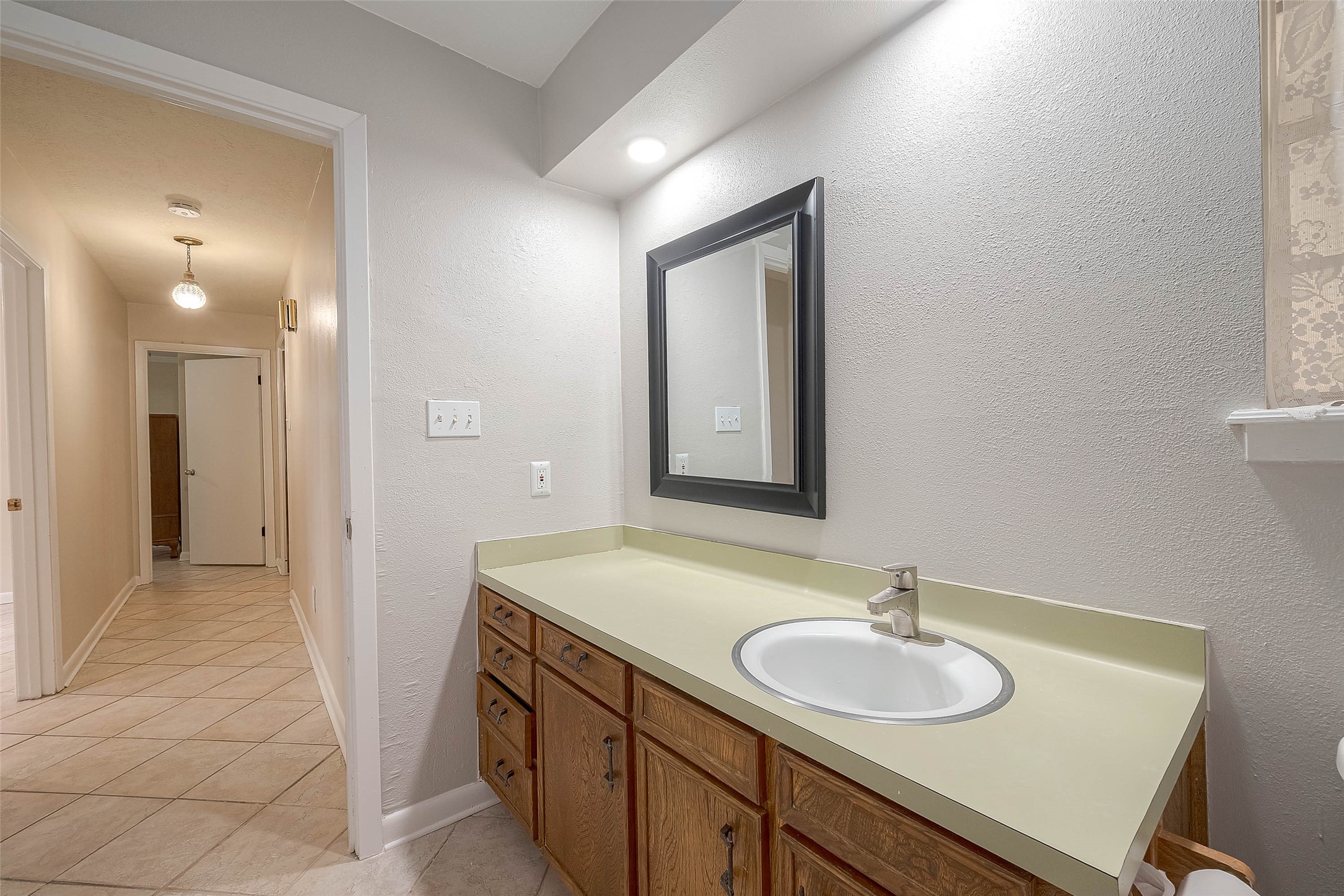 1503 Miles Street Rosenberg, TX 77471 - Photo 17 of 25 a bathroom with a sink and a mirror