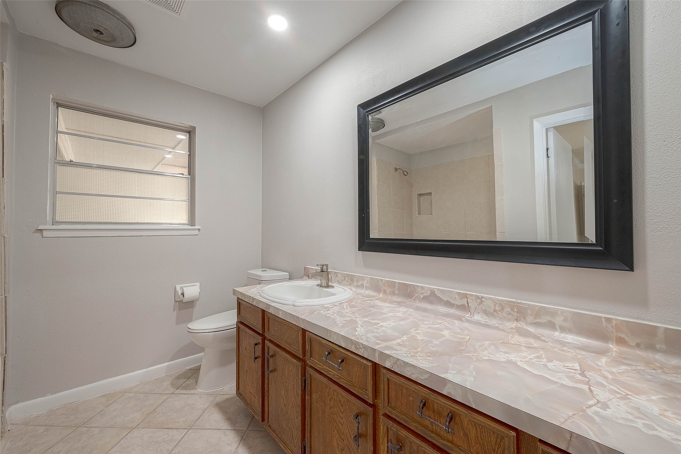 1503 Miles Street Rosenberg, TX 77471 - Photo 20 of 25 a bathroom with a sink a vanity and a mirror