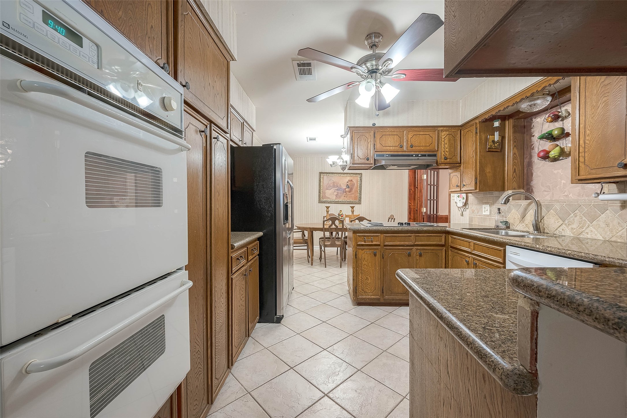 1503 Miles Street Rosenberg, TX 77471 - Photo 6 of 25 a kitchen with a refrigerator a sink and dishwasher