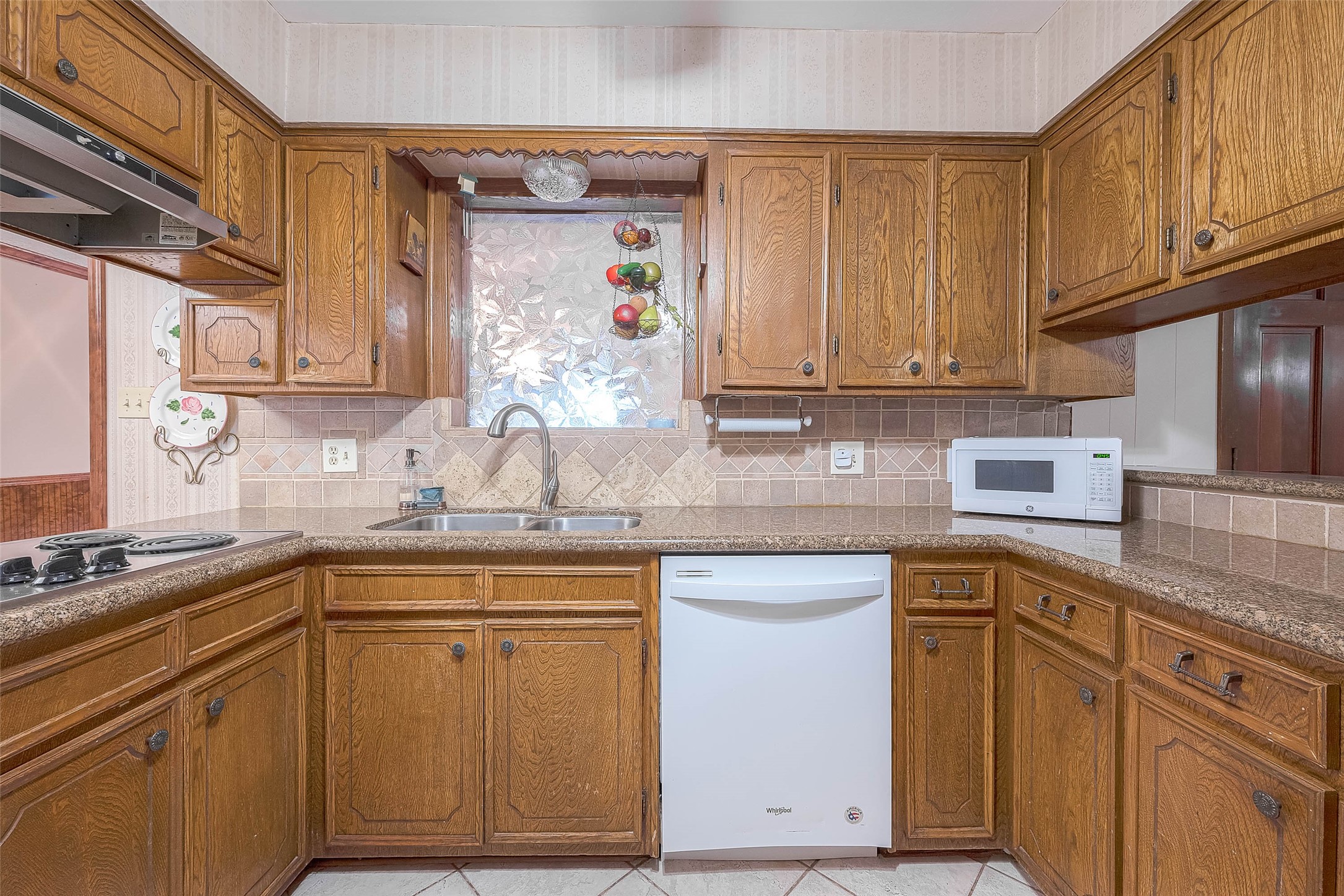 1503 Miles Street Rosenberg, TX 77471 - Photo 7 of 25 a kitchen with cabinets appliances a sink and a counter space