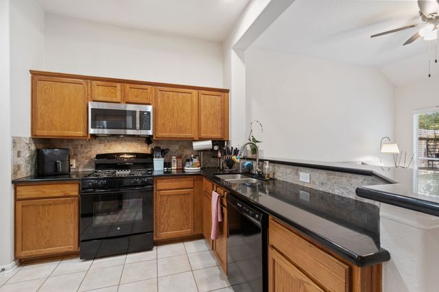 a kitchen with a sink stove and microwave