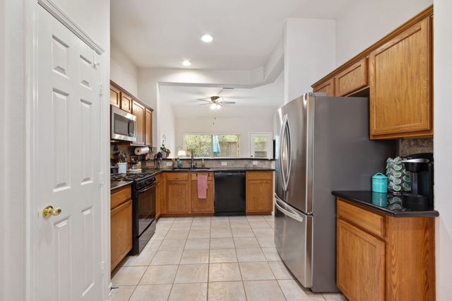 a kitchen with stainless steel appliances granite countertop a refrigerator and a sink
