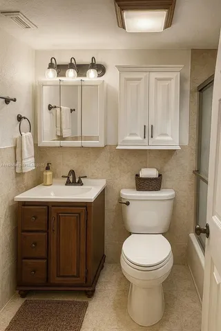 a bathroom with a toilet sink and mirror