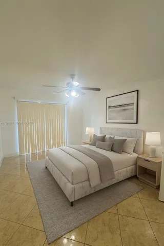 a bedroom with a bed and a lamp with the dresser