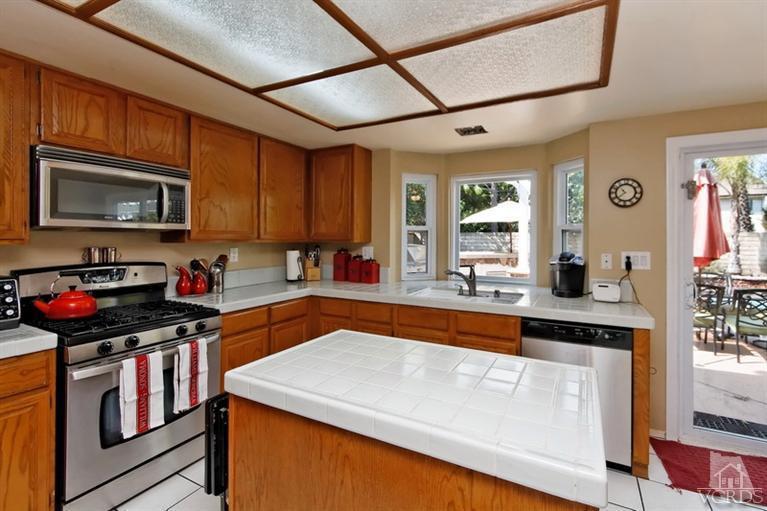 3903 Southhampton Road Moorpark, CA 93021 - Photo 12 of 29 a kitchen with stainless steel appliances granite countertop a sink stove and microwave