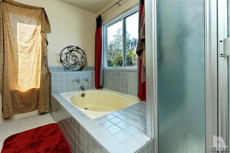 3903 Southhampton Road Moorpark, CA 93021 - Photo 17 of 29 a bath tub sitting next to a blue wall