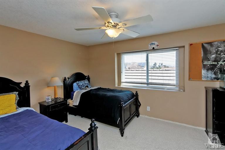 3903 Southhampton Road Moorpark, CA 93021 - Photo 18 of 29 a bedroom with a bed and a chandelier