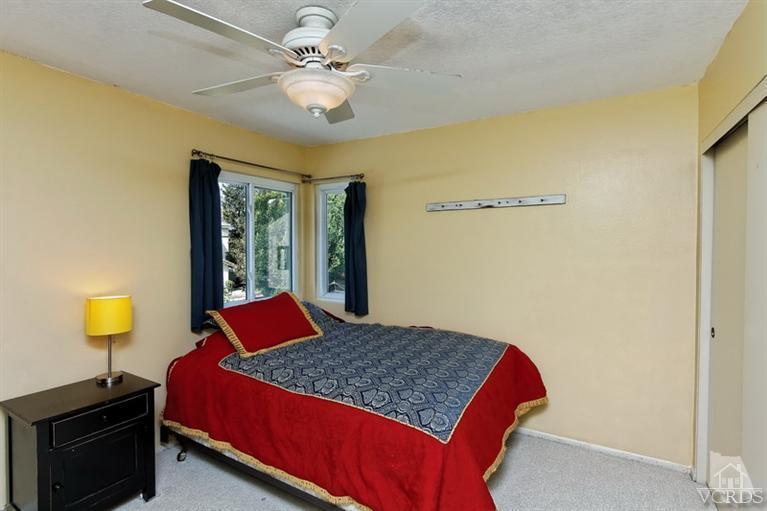 3903 Southhampton Road Moorpark, CA 93021 - Photo 20 of 29 a bedroom with a bed and a lamp on dresser