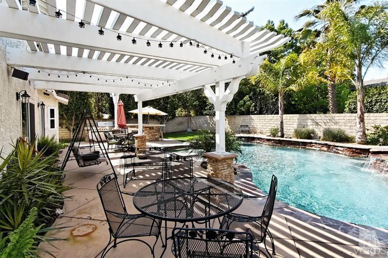 3903 Southhampton Road Moorpark, CA 93021 - Photo 24 of 29 a view of a patio with table and chairs potted plants and large tree