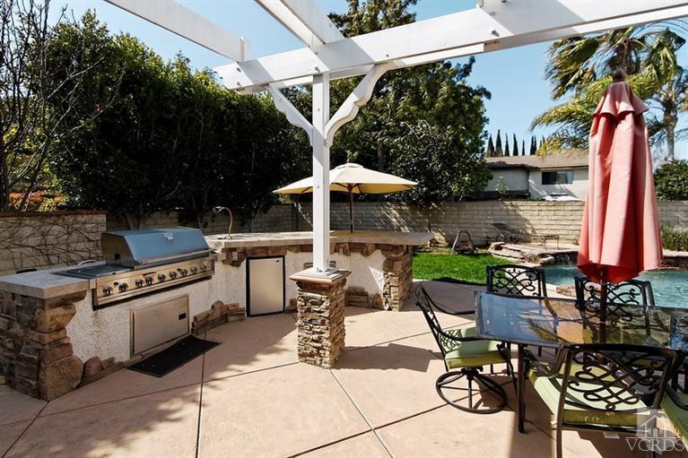 3903 Southhampton Road Moorpark, CA 93021 - Photo 25 of 29 a view of a patio with a table and chairs under an umbrella