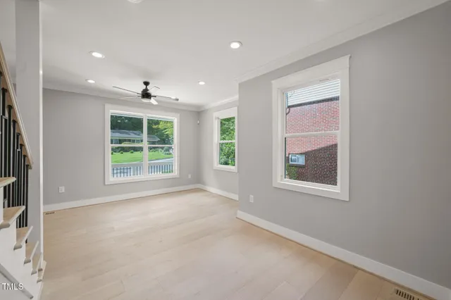 an empty room with windows and closet