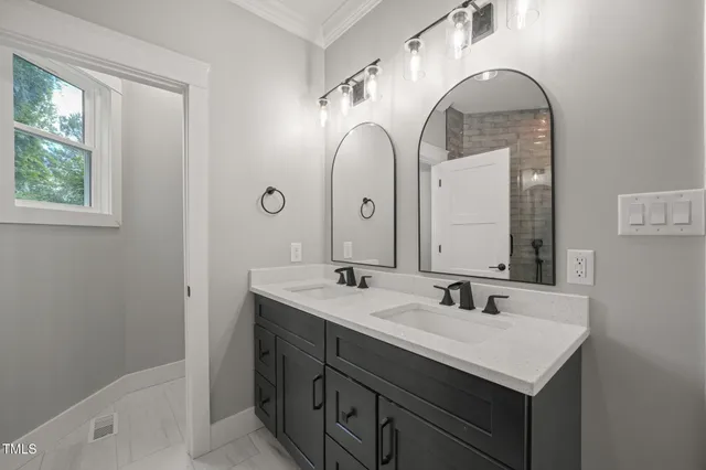 a bathroom with a double vanity sink and a mirror