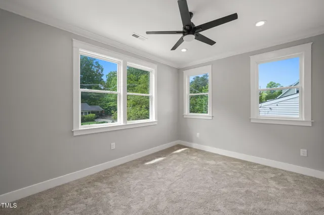 a view of a livingroom with a ceiling fan and window