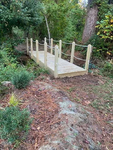 a view of a chairs and table in the backyard