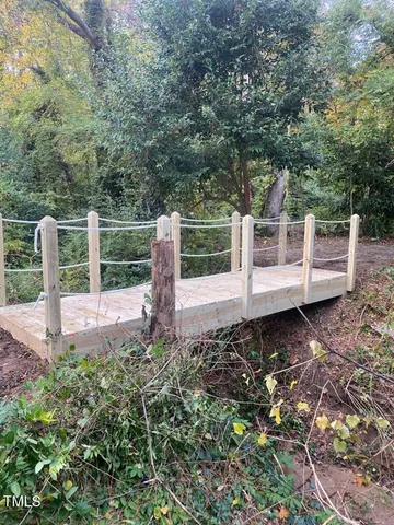 a view of a backyard with lawn chairs