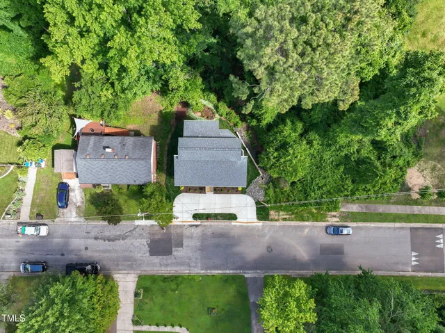 an aerial view of a house with a yard and lake view