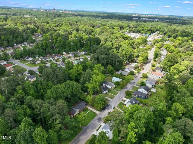 a front view of a house with plants and garage