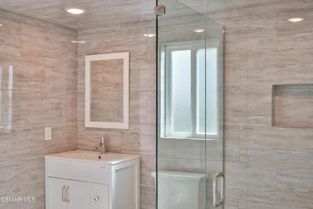 a bathroom with a sink a toilet and mirror