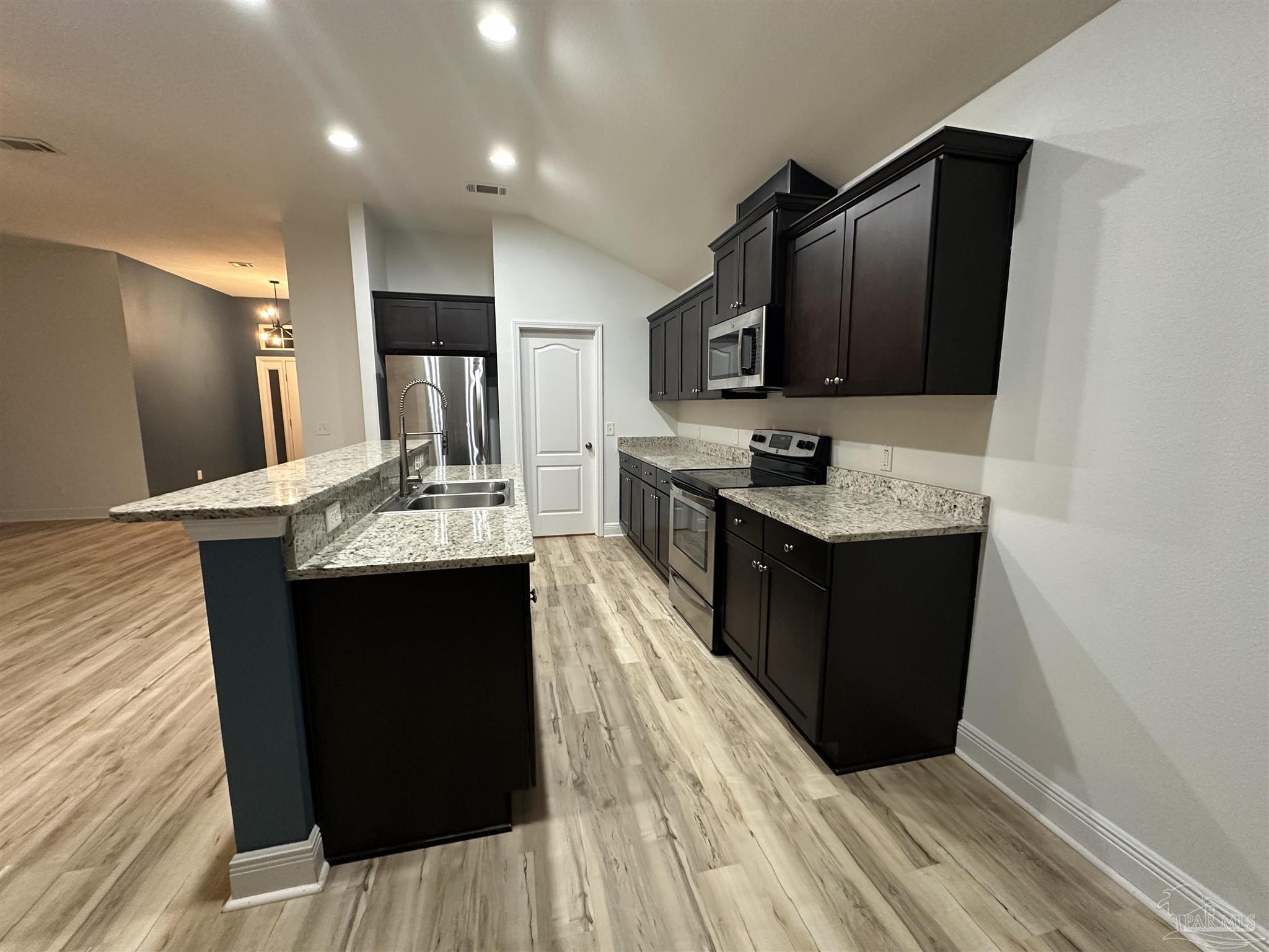 7329 Farmers Road Pensacola, FL 32526 - Photo 11 of 27 a kitchen with a sink and refrigerator