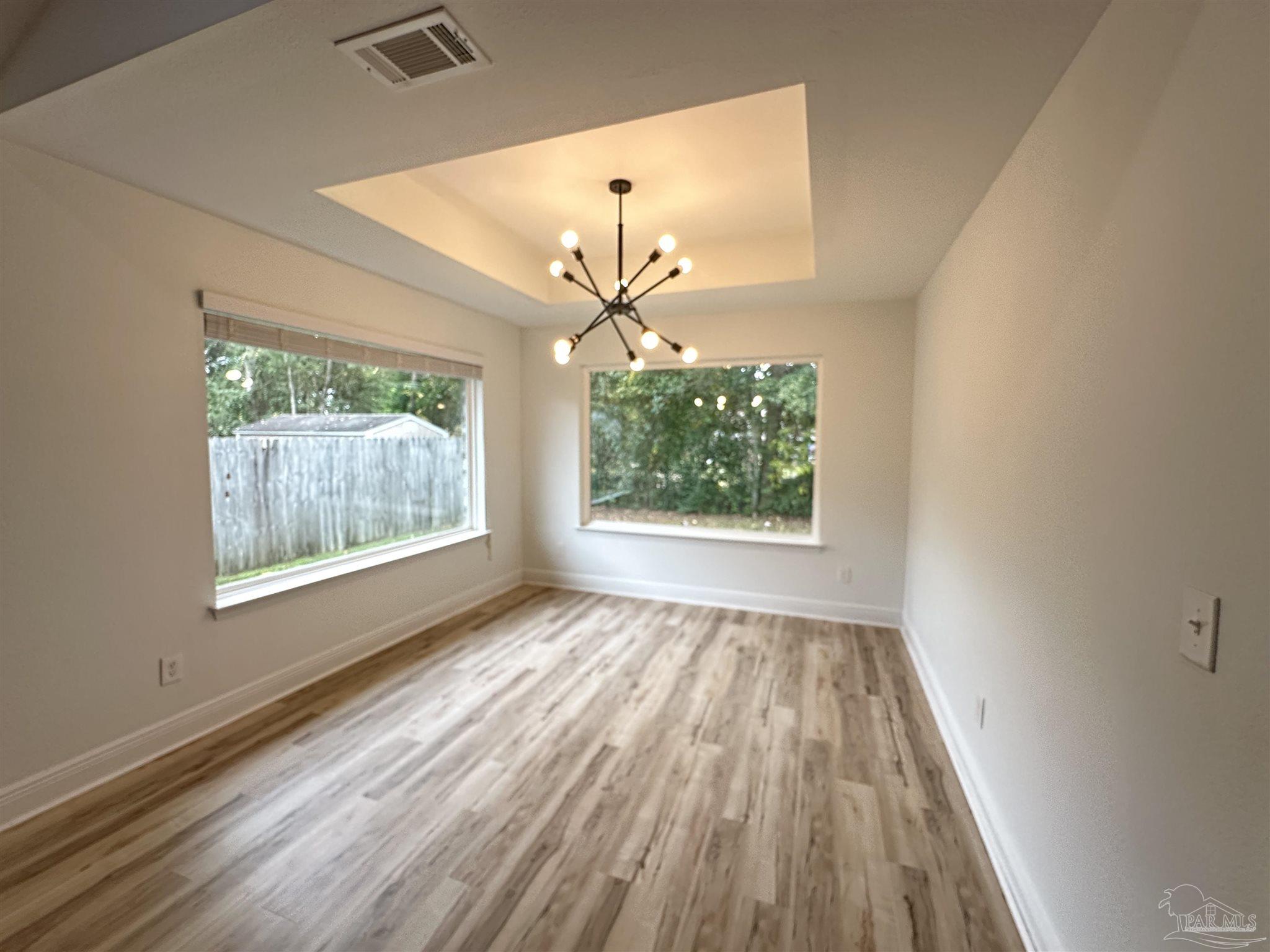 7329 Farmers Road Pensacola, FL 32526 - Photo 12 of 27 an empty room with wooden floor fan and windows
