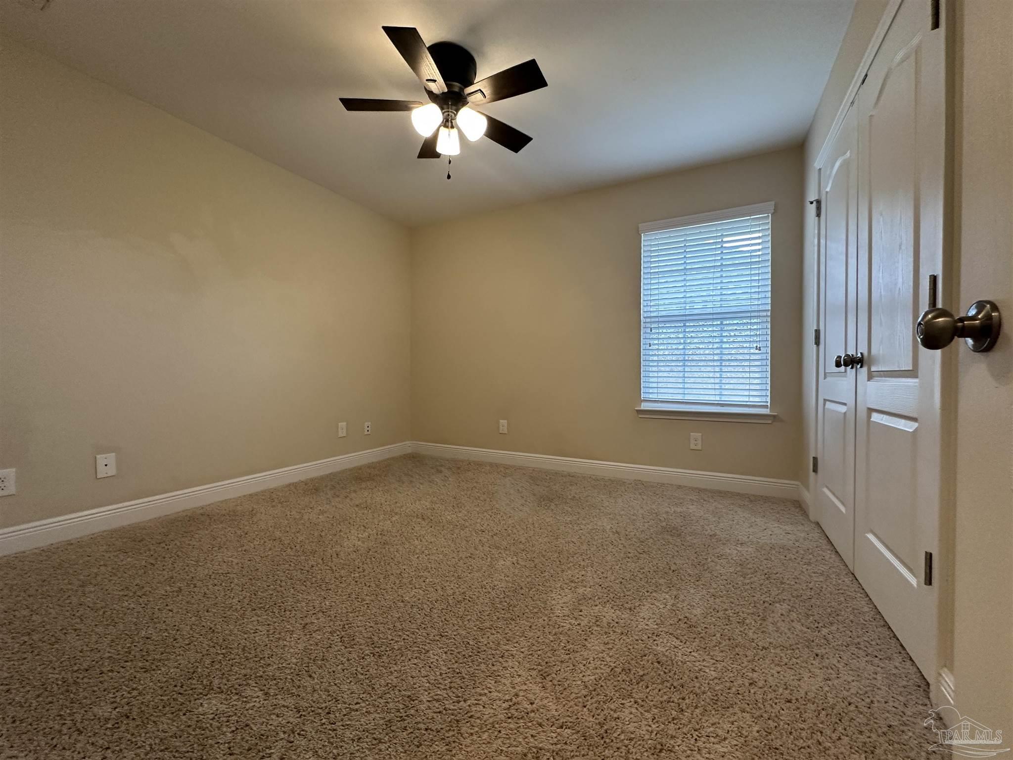 7329 Farmers Road Pensacola, FL 32526 - Photo 22 of 27 en empty room with windows and ceiling fan