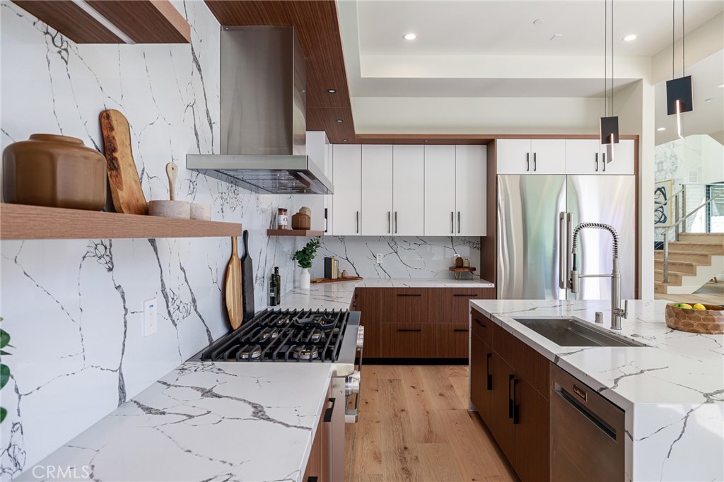 1813 Walnut Avenue Manhattan Beach, CA 90266 - Photo 22 of 73 a kitchen with stainless steel appliances a stove a sink a refrigerator and cabinets