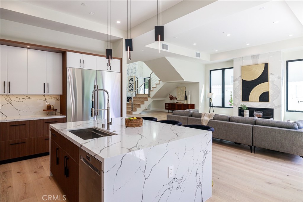 1813 Walnut Avenue Manhattan Beach, CA 90266 - Photo 23 of 73 a kitchen with stainless steel appliances kitchen island granite countertop a sink stove and refrigerator