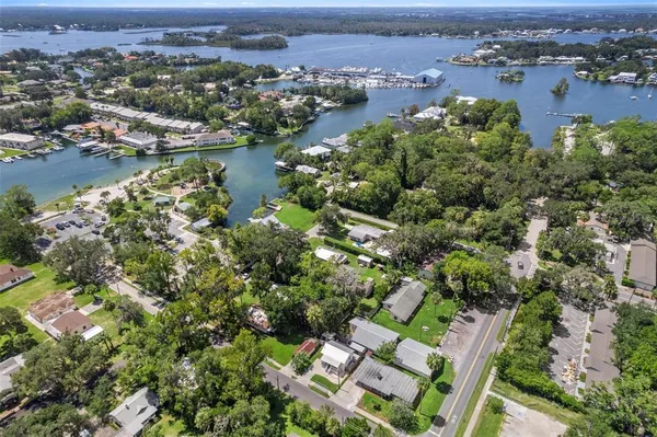 an aerial view of residential houses with outdoor space and river