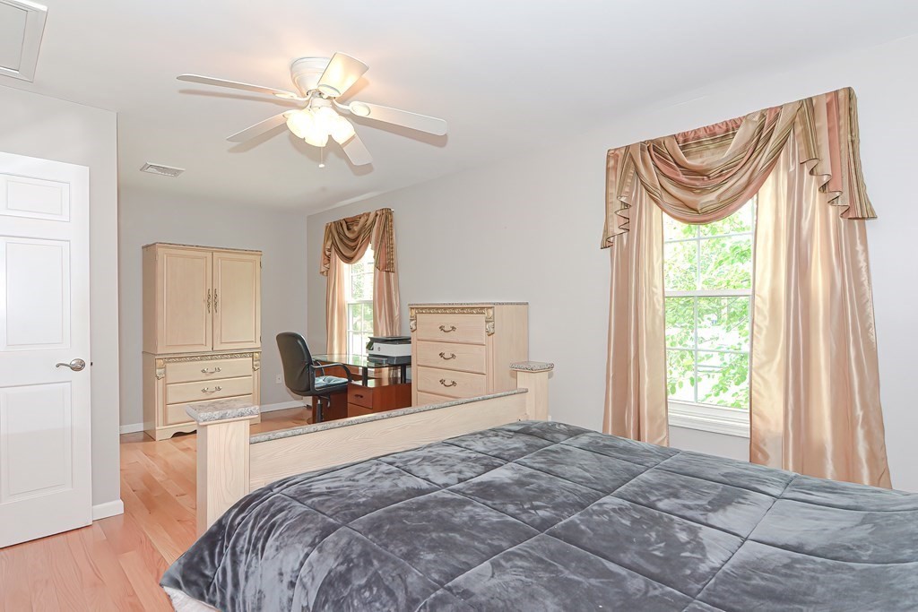 41 Boston Hill Road Fairhaven, MA 02719 - Photo 12 of 32 a bedroom with a bed and a chandelier