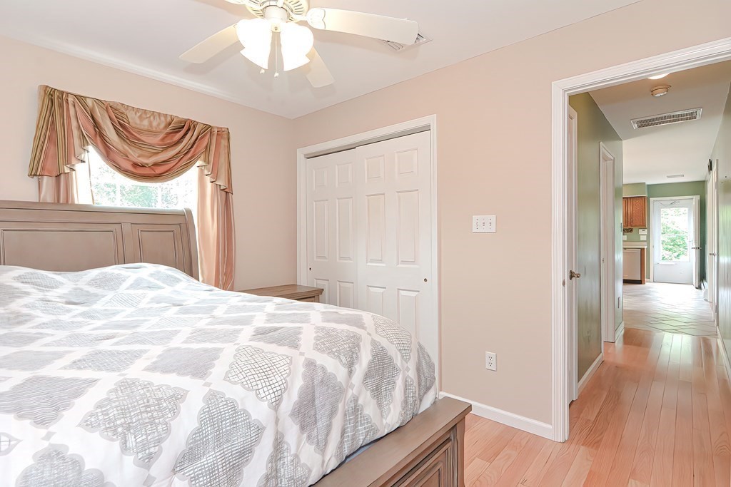 41 Boston Hill Road Fairhaven, MA 02719 - Photo 16 of 32 a bedroom with a bed and a chandelier