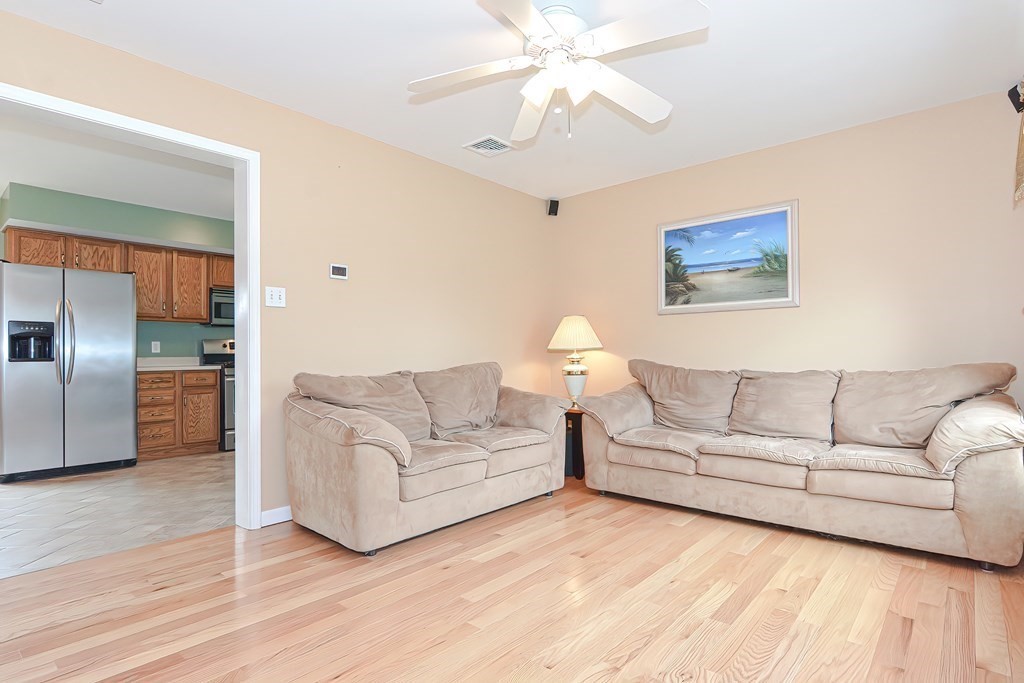 41 Boston Hill Road Fairhaven, MA 02719 - Photo 4 of 32 a living room with furniture and a chandelier