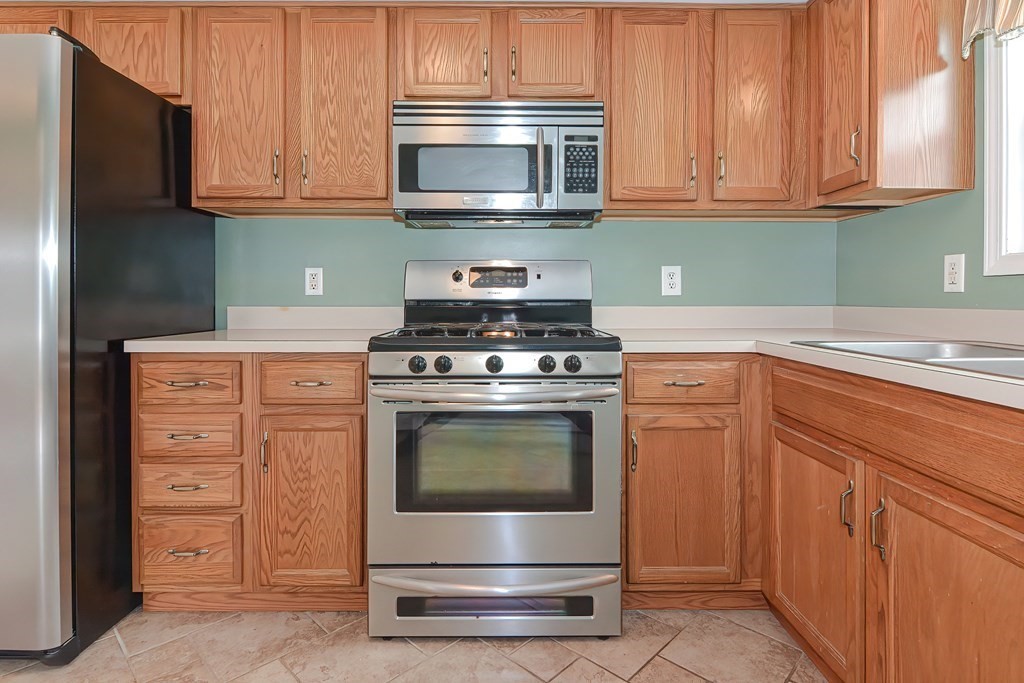 41 Boston Hill Road Fairhaven, MA 02719 - Photo 6 of 32 a kitchen with granite countertop cabinets and stainless steel appliances