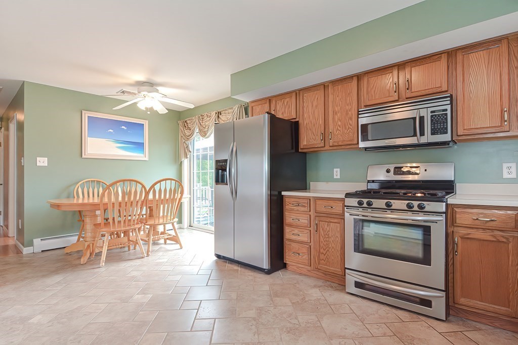 41 Boston Hill Road Fairhaven, MA 02719 - Photo 8 of 32 a kitchen with stainless steel appliances granite countertop a stove top oven a refrigerator and a microwave