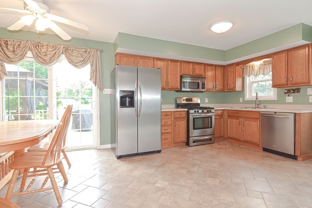 41 Boston Hill Road Fairhaven, MA 02719 - Photo 10 of 32 a kitchen with stainless steel appliances granite countertop a stove a sink a microwave and a refrigerator