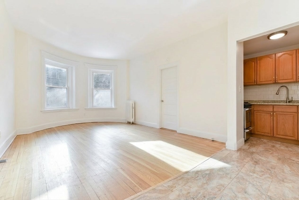 36 Winchester Street, Unit 2 Brookline, MA 02446 - Photo 3 of 14 a view of a kitchen with wooden floor and a sink
