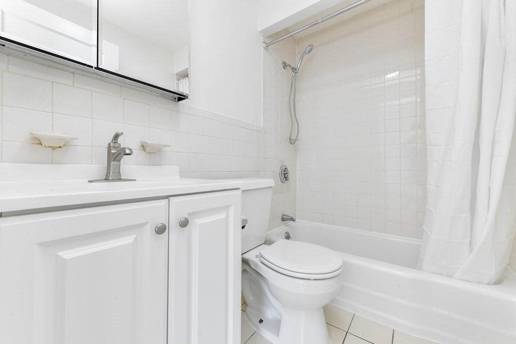 36 Winchester Street, Unit 2 Brookline, MA 02446 - Photo 9 of 14 a bathroom with a sink a toilet and shower