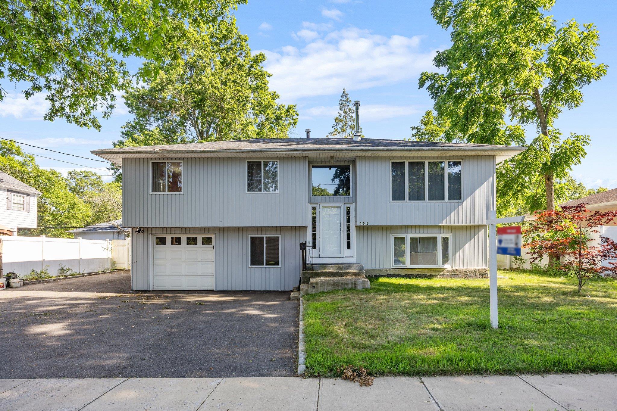 158 Wicks Road Commack, NY 11725 - Photo 1 of 1 Bi-level home with asphalt driveway