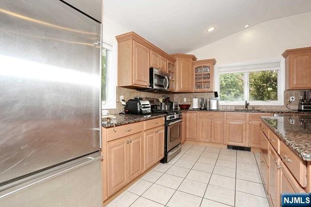 84 12th Street Cresskill, NJ 07626 - Photo 17 of 45 a kitchen with stainless steel appliances granite countertop a refrigerator and a sink