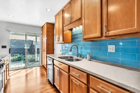 a kitchen with stainless steel appliances a sink and a large window