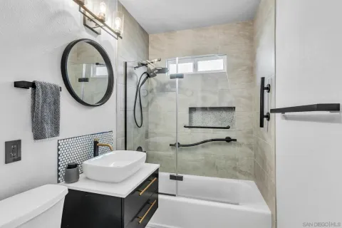 a bathroom with a sink a toilet and a mirror